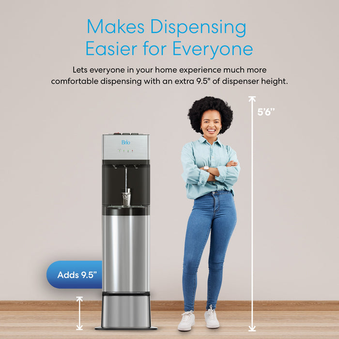 A 5'6" woman stands by a water dispenser elevated on the Brio Water Cooler Base–300, 400, 500, or 700 Series–which adds 9.5" in height for easier access and dispensing for all.