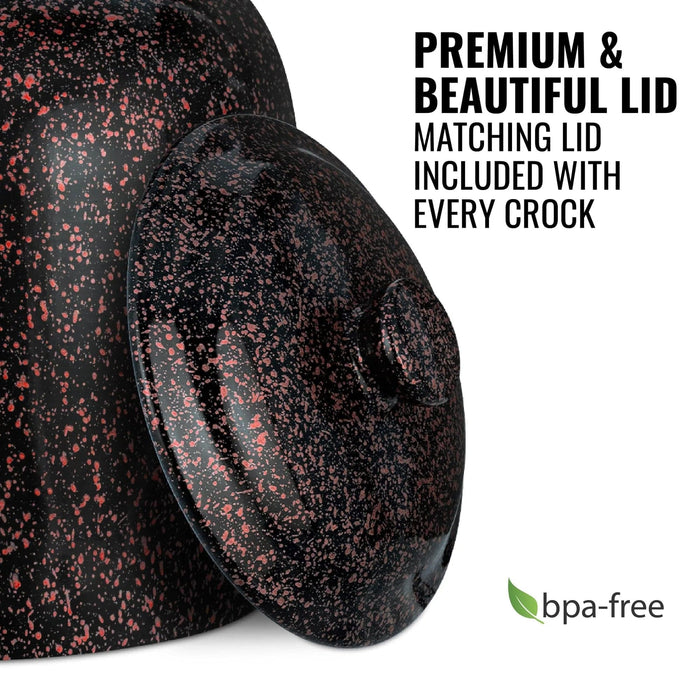 The GEO Porcelain Ceramic Crock Water Dispenser in black with red speckles is shown with its matching lid. Text reads: Premium & Beautiful Lid. Every crock includes a matching lid. A green leaf icon appears beside the words BPA-free.