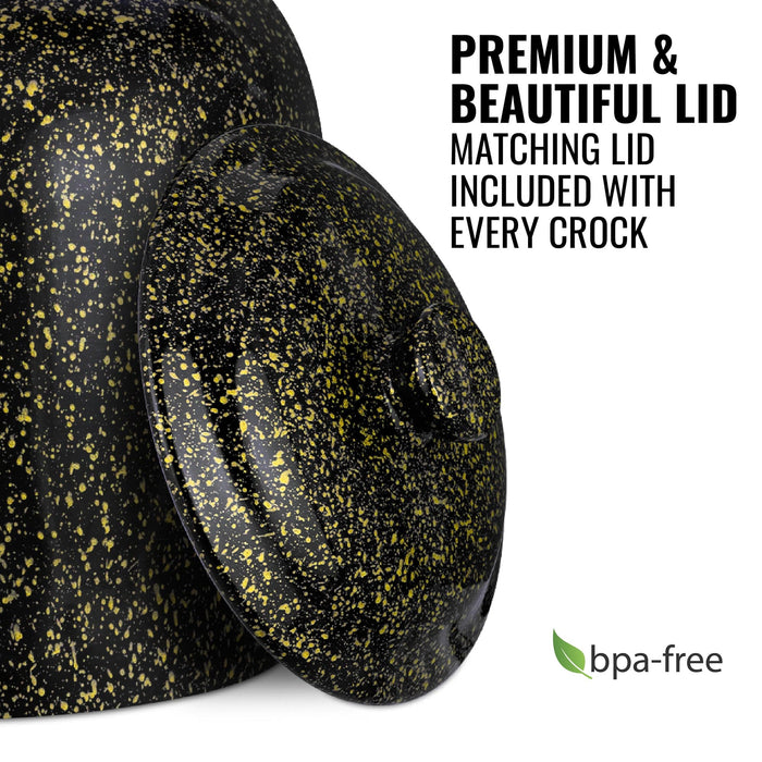 The GEO Porcelain Ceramic Crock Water Dispenser in black with yellow speckles is shown with a matching lid. Text: "Premium & Beautiful Lid." Every crock includes a matching lid. BPA-free label with green leaf appears in the corner.
