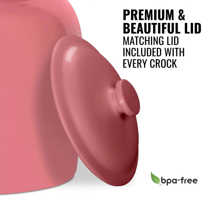 A close-up of the GEO Porcelain Ceramic Crock Water Dispenser in pink, featuring a matching lid and bold “Premium & Beautiful Lid: Matching lid included with every crock” text. A green BPA-free logo appears in the bottom right corner.