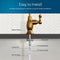 Diagram of the Brio Curvy Classic Series Water Faucet – Brushed Bronze for reverse osmosis systems, with labeled parts: rubber washer, locking nut, 4" threaded shank, locking clip, 1/4" quick connect, and 1/4" PE tubing.