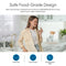 In a bright modern kitchen, a woman smiles with a glass of water, showing the Brio Curvy Classic Series Water Faucet – Brushed Gold, featuring food-grade, lead-free 304 stainless steel and safe water filtration benefits.