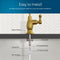 Diagram showing the installation of the Brio Curvy Classic Series Water Faucet – Brushed Gold, with labeled parts: rubber washer, locking nut, threaded shank, locking clip, 1/4 quick connect, and 1/4 PE tubing under a countertop.
