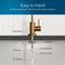 A diagram displays the Brio Modern Series Water Faucet – Brushed Bronze installed, labeling its rubber washer, locking nut, locking clip, 4" threaded shank, 1/4" quick connect, and PE tubing—perfect for reverse osmosis setups against a tile backsplash.