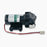 Black Diaphragm Pump for TROE 1000 & 1200 tankless units with cylindrical body, mounting base, attached wires, and white plastic fittings. Visible label on the side. Photographed against a white background.
