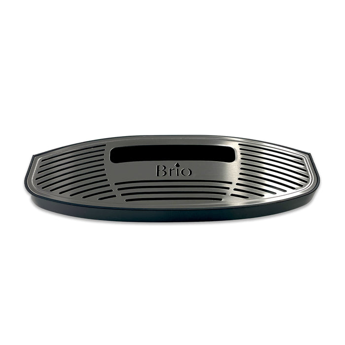 A black, oval plastic drip tray for Brio 320, 420 & 520 Series Icemaker Coolers features a grated surface, rectangular center cutout, and "Brio" embossed near the middle.