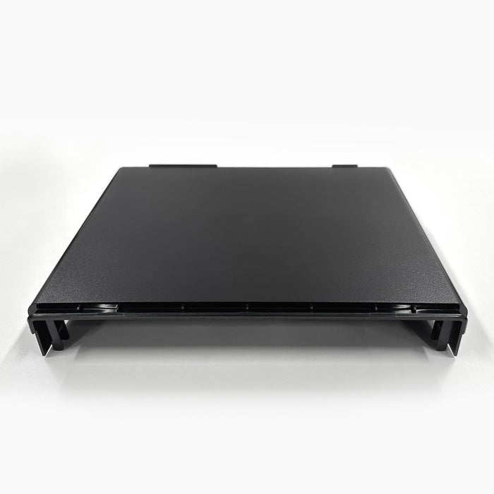 A black, rectangular Top Lid 520 Series Cooler stand is shown on a white surface, viewed from the front at a slight angle. It features raised edges and four short legs.