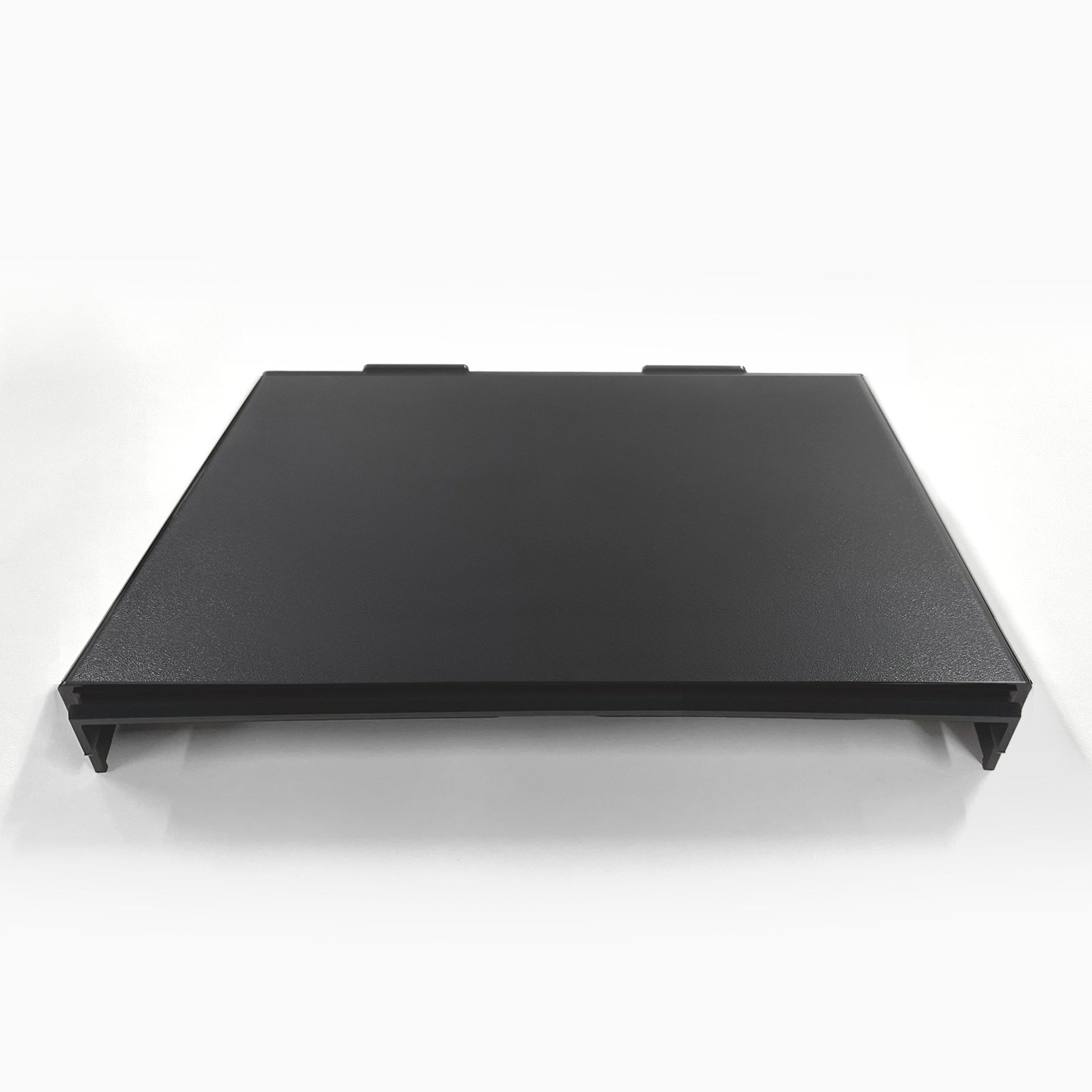 A black, rectangular Top Cover for Brio 320, 420 & 520 Series Icemaker Coolers with two tabs on the back edge, shown flat on a white surface against a plain white background.