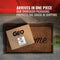 A box labeled GEO Porcelain Ceramic Crock Water Dispenser – Dark Gray Speckled sits by a red door. Text above reads: Arrives in one piece. Our sturdy packaging protects your ceramic dispenser throughout shipping.