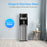 The Brio 400 Series Bottom Load Water Cooler features a sleek stainless steel design, enhancing any modern room with light wood floors and stylish décor, making it both elegant and functional.